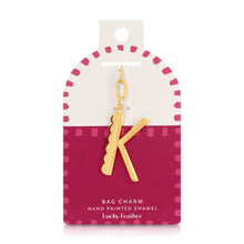 Load image into Gallery viewer, 14K gold-plated hand-painted enamel initial bag charm featuring the letter K with a scalloped edge design and a brushed gold finish, attached to a key ring and clasp. Displayed on a white and deep pink Lucky Feather card with a pink dotted brush-stroke borders labeled &quot;Bag Charm Hand Painted Enamel.&quot; Displayed on a white background. 