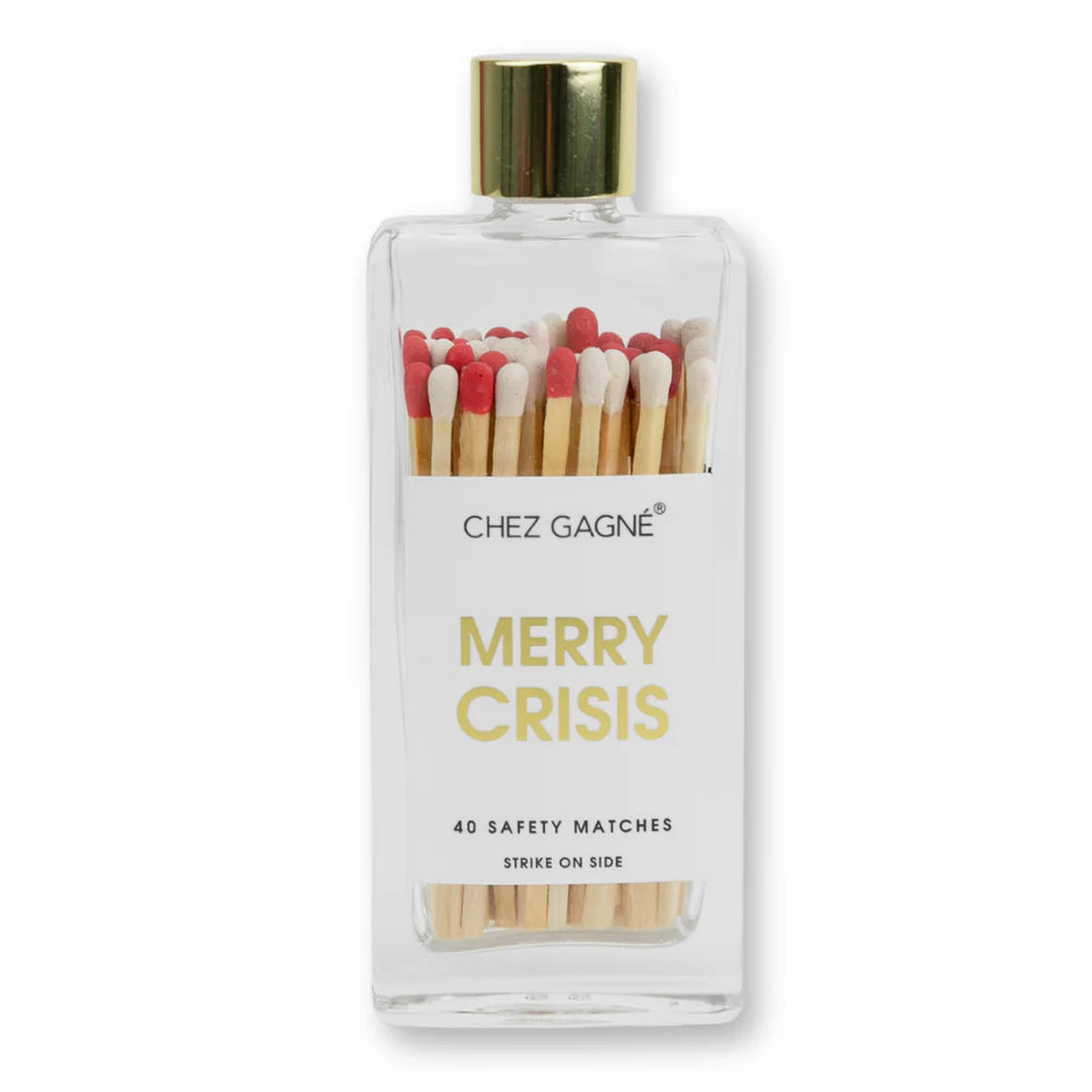 A glass container with a gold cap and a white label , with red and white tipped matches inside. White label has 