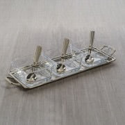 Load image into Gallery viewer, Rectangular metal condiment tray with two side handles, holding three square clear glass bowls with matching spoons, displayed on a light-colored surface.  