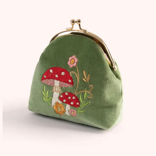 Green velvet coin purse with embroidered red polka dot mushrooms, pink and yellow flowers, with a gold metal clasp. Against a white background. 