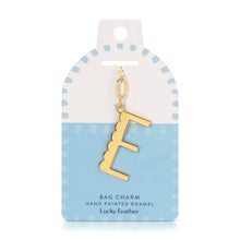 Load image into Gallery viewer, 14K gold-plated hand-painted enamel initial bag charm featuring the letter E with a scalloped edge design and a brushed gold finish, attached to a key ring and clasp. Displayed on a white and light blue Lucky Feather card with light blue dotted brush-stroke borders labeled &quot;Bag Charm Hand Painted Enamel.&quot; Displayed against a white background.