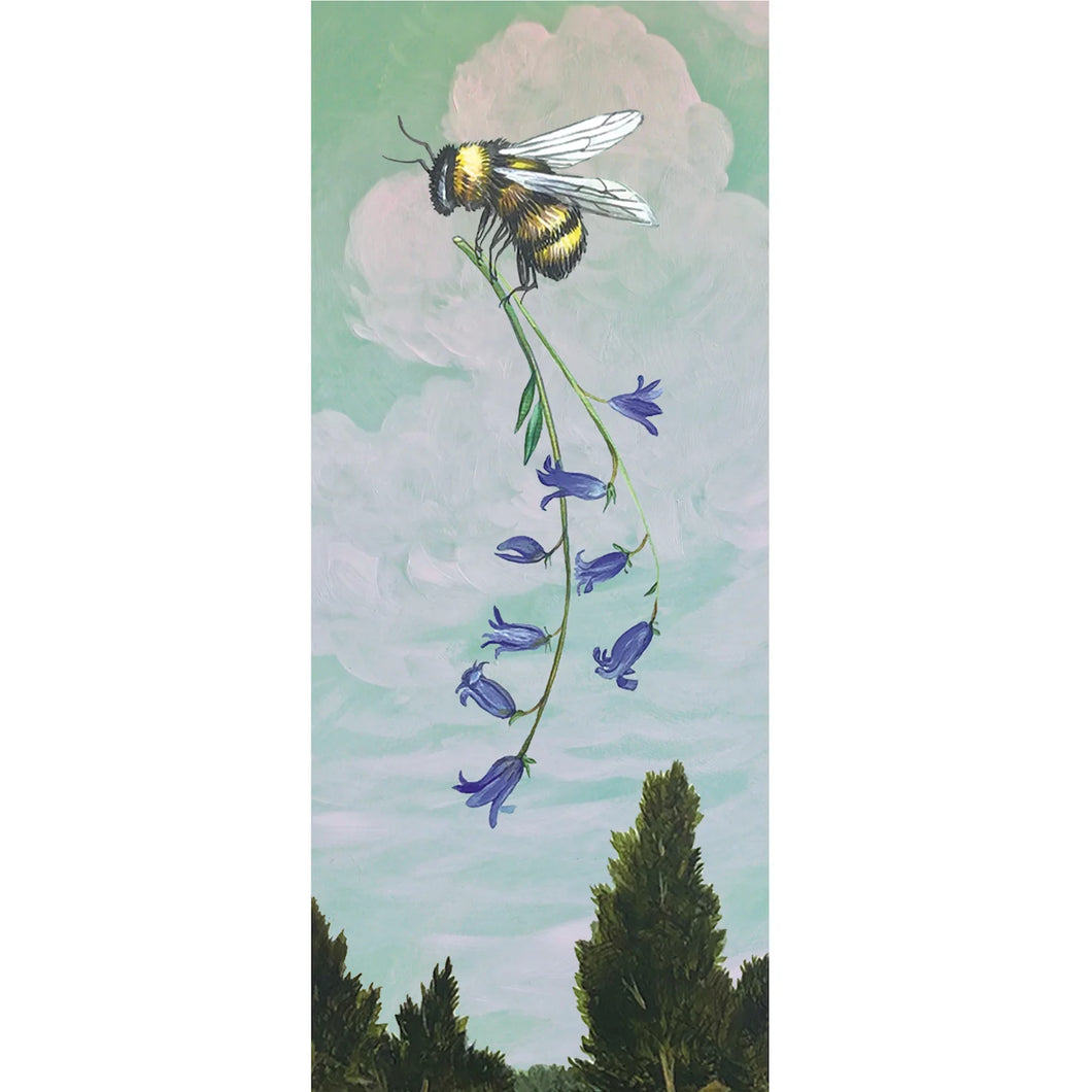 Tall notecard printed with a blue sky and fluffy white clouds. Pine trees line the bottom. In the center of the sky is bumblebee holding a sprig of violet flowers. White background.