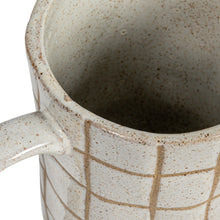 Load image into Gallery viewer, Close-up of a beige  ceramic mug with a grid pattern on a white background.