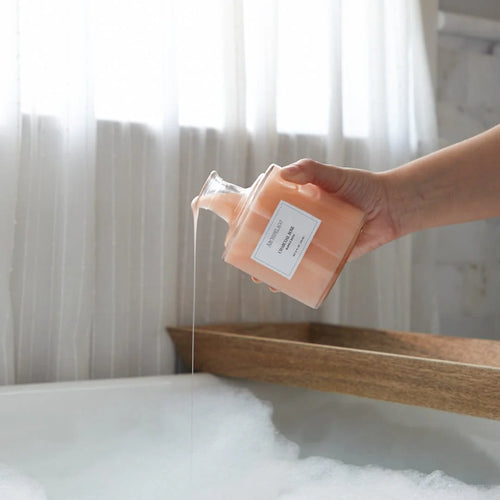 Square glass bottle with a white label and  