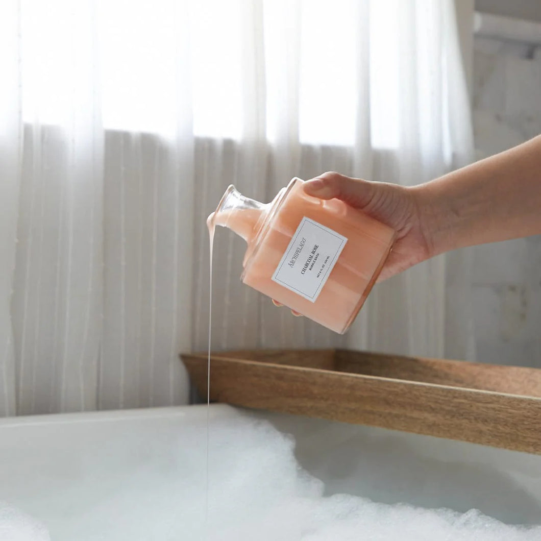 Square glass bottle with a white label and  