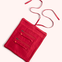 Load image into Gallery viewer, Open red velvet jewelry roll with two zippered compartments and two ring / accessory holders with a matching red ribbon tie displayed flat on a white background.  