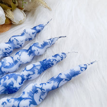 Load image into Gallery viewer, Blue-and-white floral twisted taper candles made of paraffin wax, arranged on a white textured surface.