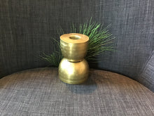 Load image into Gallery viewer, Short brass candlestick holder with textured surface against a gray background with greenery.
