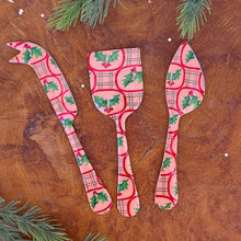 Load image into Gallery viewer, A set of pink enameled stainless steel servers with a mistletoe design in red and green. On a brown wooden surface with green fir tree cuttings. 