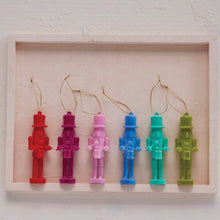 Load image into Gallery viewer, Six nutcracker drummer ornaments in red, magenta, pink, blue, teal, and lime green displayed in a light pink box frame against a light pink textured background. 