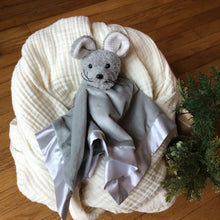Load image into Gallery viewer, Gray plushie blanket with a mouse head , cradled in white muslin blanket on wooden background with greenery.