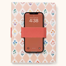Load image into Gallery viewer, A pink and white checkered notebook with different color flowers in the white checkers. Notebook has a coral color cell phone holder with a cell phone inside it. Cell phone has a brick color screen and &quot;4:38&quot; for the time . Notebook is against a white background.