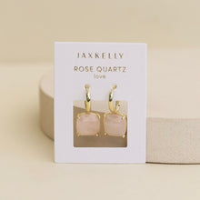 Load image into Gallery viewer, Rose quartz cushion-shaped drop earrings with gold-tone huggie hoops on white JAXKELLY display card.