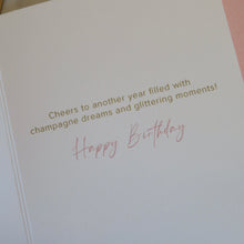 Load image into Gallery viewer, Birthday card with text &quot;Cheers to another year filled with champagne dreams and glittering moments! Happy Birthday&quot; on a pink background.