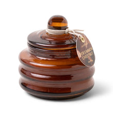 Load image into Gallery viewer, Brown glass container with candle, and a tag on a white background.
Glass is ribbed with a knob on top. Partial view of a brown tag with &quot;PERSIMMON CHESTNUT&quot; text.