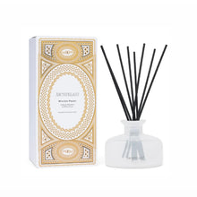 Load image into Gallery viewer, Archipelago Winter Frost fragrance glass diffuser with black reeds beside its decorative metallic gold and white box, displayed on a white background.