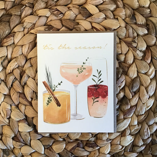 holiday card with holiday drinks and gold writing 