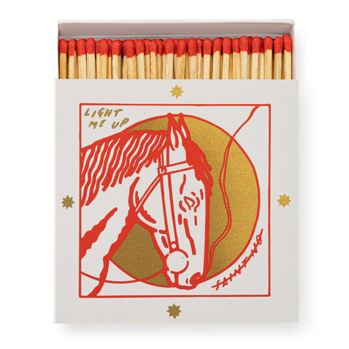 A white box of opened matches with red tipped matches. Box has 