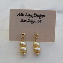 Load image into Gallery viewer, Pair of pearl colored beaded earrings on a card with &quot;Abbe Long Designs San Diego, CA&quot; text.