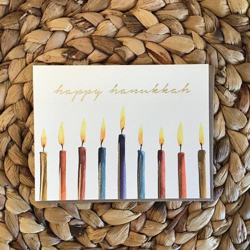 hanukkah holiday card with candles and gold writing 