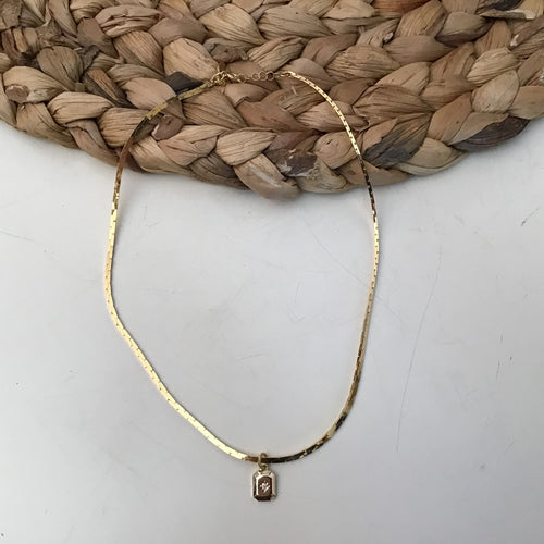 gold choker style with small medallion drop. 