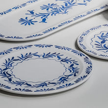 Load image into Gallery viewer, White melamine dinner plates with a blue floral pattern on a white surface with a matching platter in the background.