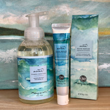 Load image into Gallery viewer, Mangiacotti Ocean foaming hand wash pump bottle and hand repair cream tube with matching box, blue and green watercolor ocean design, on wooden surface with ocean artwork background.