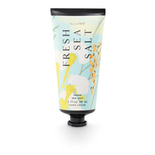 Load image into Gallery viewer, Fresh Sea Salt Demi Hand Cream, pale blue tube with orange, yellow, and white botanical accents, a black cap, and black crimped end displayed upright against a white background. 