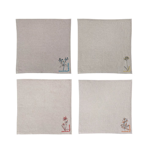 A set of four beige embroidered napkins, each with a different floral embroidery design in the corner, on a white background.