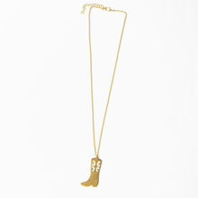 Load image into Gallery viewer, A brass necklace with a cowboy pendant on a white background.