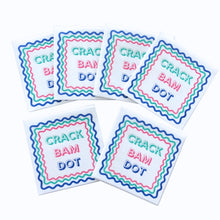Load image into Gallery viewer, Set of white cocktail napkins printed with "CRACK BAM DOT" in colorful lettering and framed by wavy multicolored borders, with several napkins fanned out on a white background.