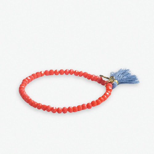 A red beaded stretch bracelet with a blue tassel end, displayed against a white background.