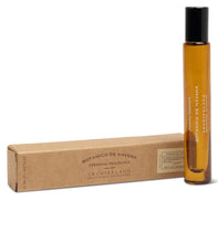 Load image into Gallery viewer, Amber glass Botanico de Havana personal fragrance rollerball with black cap displayed beside brown branded box against a white background.  
