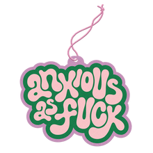 Load image into Gallery viewer, Air freshener in a retro bubble-letter design reading &quot;Anxious as Fuck&quot; in white text on a green background with a lavender border, hanging from a lavender string against a black and gray background.  