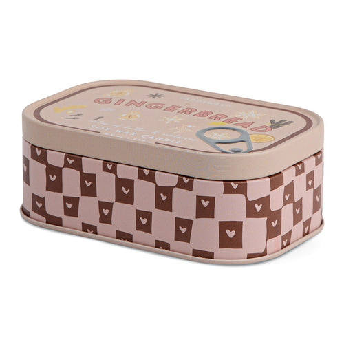 Rectangular pink and brown tin candle labeled 