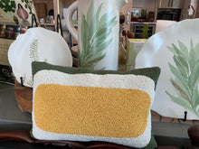 Load image into Gallery viewer, Beaded Lumbar Pillow, mustard yellow, white, and olive green lumbar pillow with geometric beaded pattern, displayed in retail store setting with green botanical plates and pitcher. 