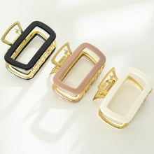 Load image into Gallery viewer, Three rectangular metal claw clips in black, tan, and white with gold hardware displayed on a white background.