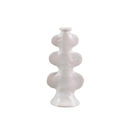 White ceramic taper candle holder  with an embossed design on a white background.