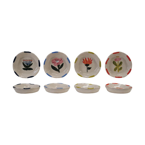A set of four ceramic dishes with various floral designs sitting upright , and four ceramic dishes sitting flush showing side profile, on a white background.