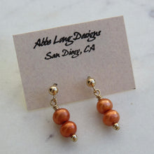 Load image into Gallery viewer, Pair of  coral beaded earrings on a card with &quot;Abbe Long Designs San Diego, CA&quot; text.
