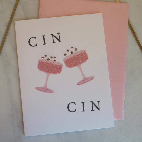 Greeting card with pink champagne glasses and sparkly bubbles and  