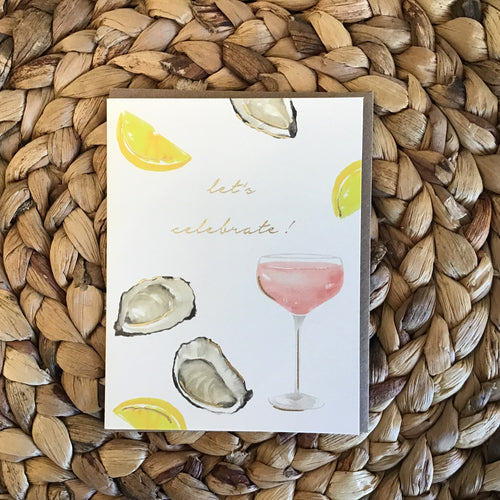 Birthday card with oysters, lemons, chamange, and gold writing 