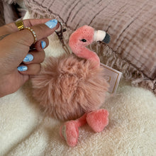 Load image into Gallery viewer, Person with blue manicured nails holding a pink plush flamingo with a fuzzy mauve- colored middle with a silver clasp. On a soft white surface with a pink textured textile in the background.