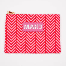 Load image into Gallery viewer, Red and pink chevron-patterned Mahjong accessory bag with a gold zipper and a pink rectangular patch with "MAHJ" on it, displayed on a white surface.