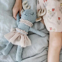 Load image into Gallery viewer, Gray wool-blend deer doll with sparkly gold antlers and ears, black embroidered sleepy eyes, a beige ruffle collar,  and a matching tulle skirt, displayed in a child&#39;s hand on a gray blanket. 