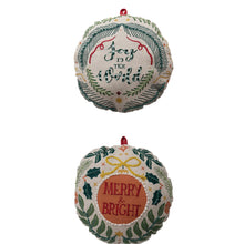 Load image into Gallery viewer, Two white round ornament-shaped embroidered Christmas pillows , &quot;Joy To The World&quot; and &quot;Merry &amp; Bright&quot;, shown side-by-side against a white background with red hanging loops. 