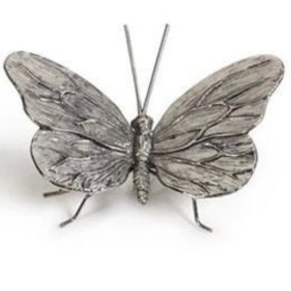 Antiqued pewter butterfly on a white background.
