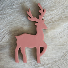 Load image into Gallery viewer, Pink Dancing Deer, close-up overhead view of a pink mango wood deer with branching antlers, one raised front leg, and visible natural wood edges, lying on white fur.