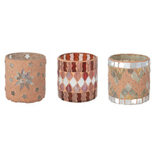 Load image into Gallery viewer, Three glass mosaic votive candle holders in varying patterns displayed side by side on a white background. The left holder features small mosaic stars and a central starburst design on a pink base. The middle holder showcases red, pink, and white diamond tiles bordered by red and pink wavy mosaic stripes. The right holder has an iridescent white mosaic tile border with gray diamond tiles on a pink base.  