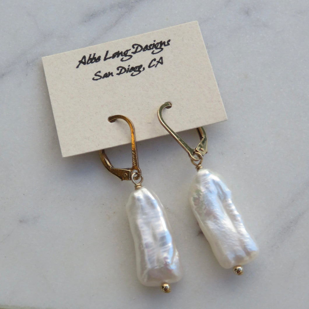 Pearl earrings on a card with 